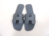 grey sandals with two straps on the toes and a white background