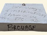 a plaque with writing on it on a white surface