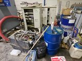 a lot of trash in a room with a blue barrel