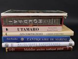 several books stacked on top of each other on a black surface