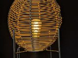 a lamp that is on a stand in the dark