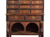 an old wooden cabinet with many drawers on top of it
