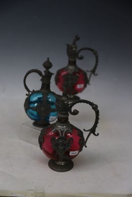 three glass vases sitting next to each other on a table