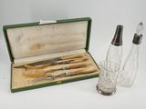 a glass bottle with a knife and a glass salt shaker in it