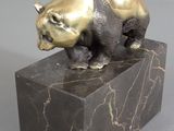 statue of a bear on a marble base on a gray background