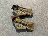 two pairs of shoes that are sitting on the floor