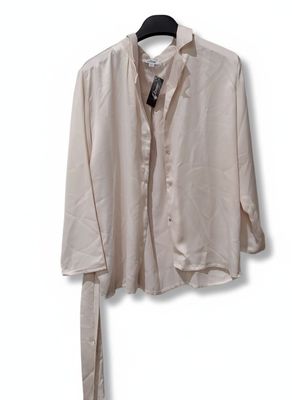 shirt on a hanger on a white wall with a black tie