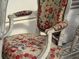 two chairs sitting next to each other on a tiled floor
