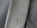 a close up of a piece of black leather with a small spot on it