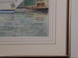 a picture of a ship in the water with a boat in the background