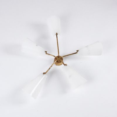 a brass and frosted glass chandelier with six arms