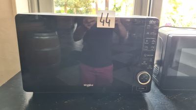 someone is taking a picture of a microwave on a table