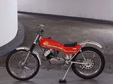 a red motorcycle parked in a parking garage next to a wall