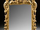an image of a mirror with a gold frame on a white surface