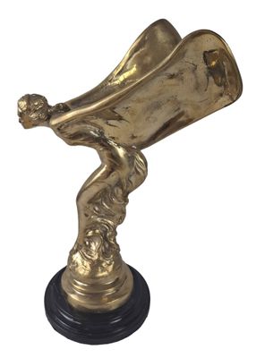 brass statue of a man holding a trumpet on a black base