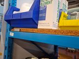 a shelf with boxes and containers on it in a warehouse