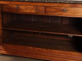 a wooden cabinet with a marble top in a room