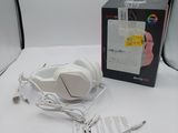 a white headphone sitting on a table next to a box