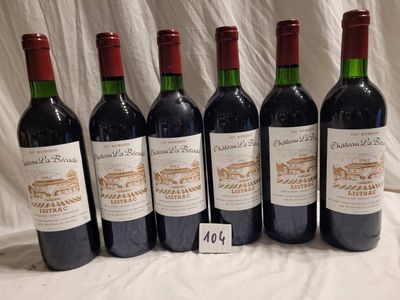 six bottles of red wine are lined up on a table