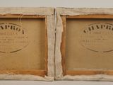 pair of framed photographs of a couple of wine bottles in a wooden box