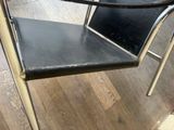 a black chair that is sitting on a wooden floor