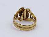 a close up of a gold ring on a white surface