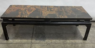 a black and gold coffee table sitting on top of a tiled floor