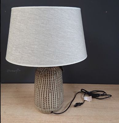 a lamp that is sitting on a table with a cord plugged into it