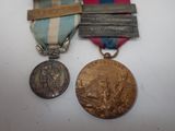 two medals and a medal are sitting on a table