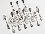 several forks and spoons are arranged in a row on a white surface