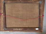 an old picture frame with a red string attached to it