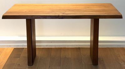 a wooden table sitting on top of a hard wood floor