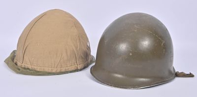 two helmets are sitting next to each other on a white surface
