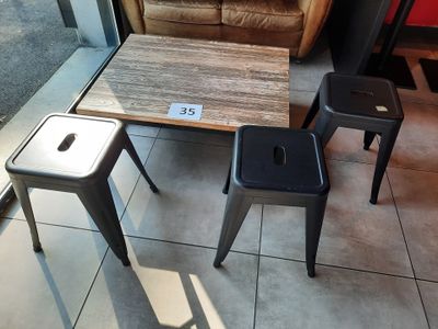 trois tabourets et une table dans une pièce