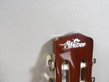 a guitar that is sitting on a stand on the floor