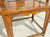 a wooden chair that is sitting on a tile floor