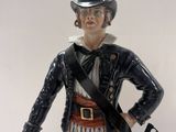 a figurine of a man with a hat and a gun