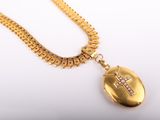 a close up of a gold necklace with a cross on it