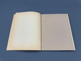 an open book with a blank page on a blue surface