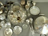 a lot of silver items on the table together