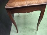 a small wooden table with a drawer on top of it