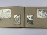 an open book with pictures of people and animals on it