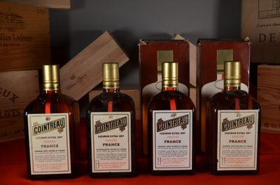 three bottles of wine sitting on top of a table next to wooden boxes