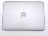 hp laptop computer sitting on a white surface with a logo on the screen