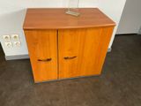 a small wooden cabinet with a lamp on top of it