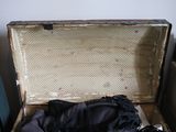 an open suitcase with a black cloth inside of it