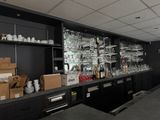 a bar with a lot of bottles and glasses on the shelves