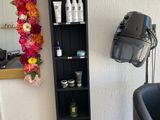 a black chair in a room with a mirror on the wall