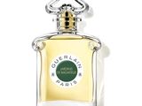 the bottle of perfume is sitting on a white surface