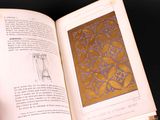 someone is holding a book open to a page with a drawing of a clock on it